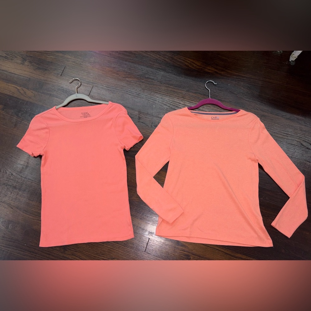 Two women’s coral colored tops